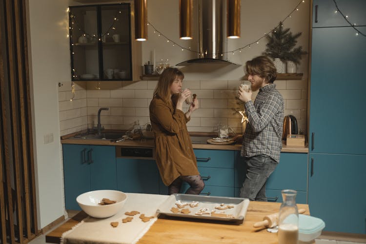 Man And Woman Eating And Drinking At Breaktime