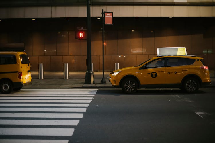 Comfortable Taxi Car Stopped Near Traffic Light On City Street