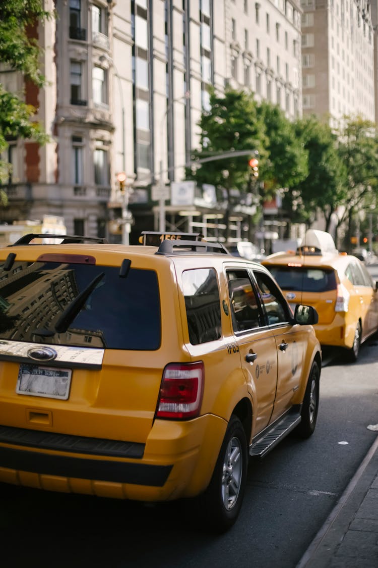 Yellow Crossover Taxis On Street In Sunlight