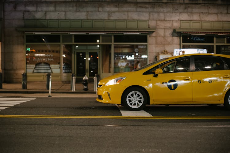 Prestige Taxi Car Parked Near Building In Evening