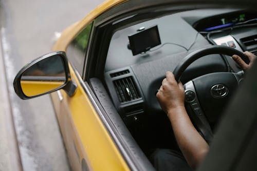 Free Faceless person driving contemporary cab in city Stock Photo