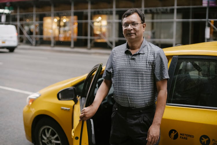 Mature Man In Glasses At Yellow Taxi