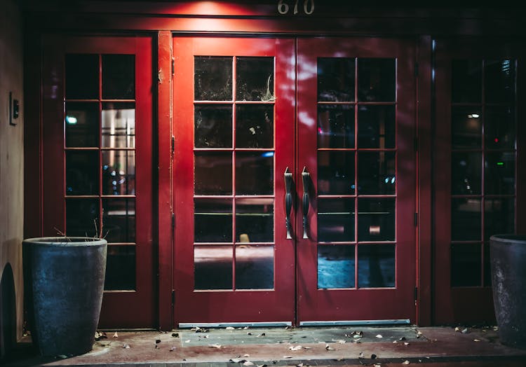 Red Glass Door Of Building Of Pub