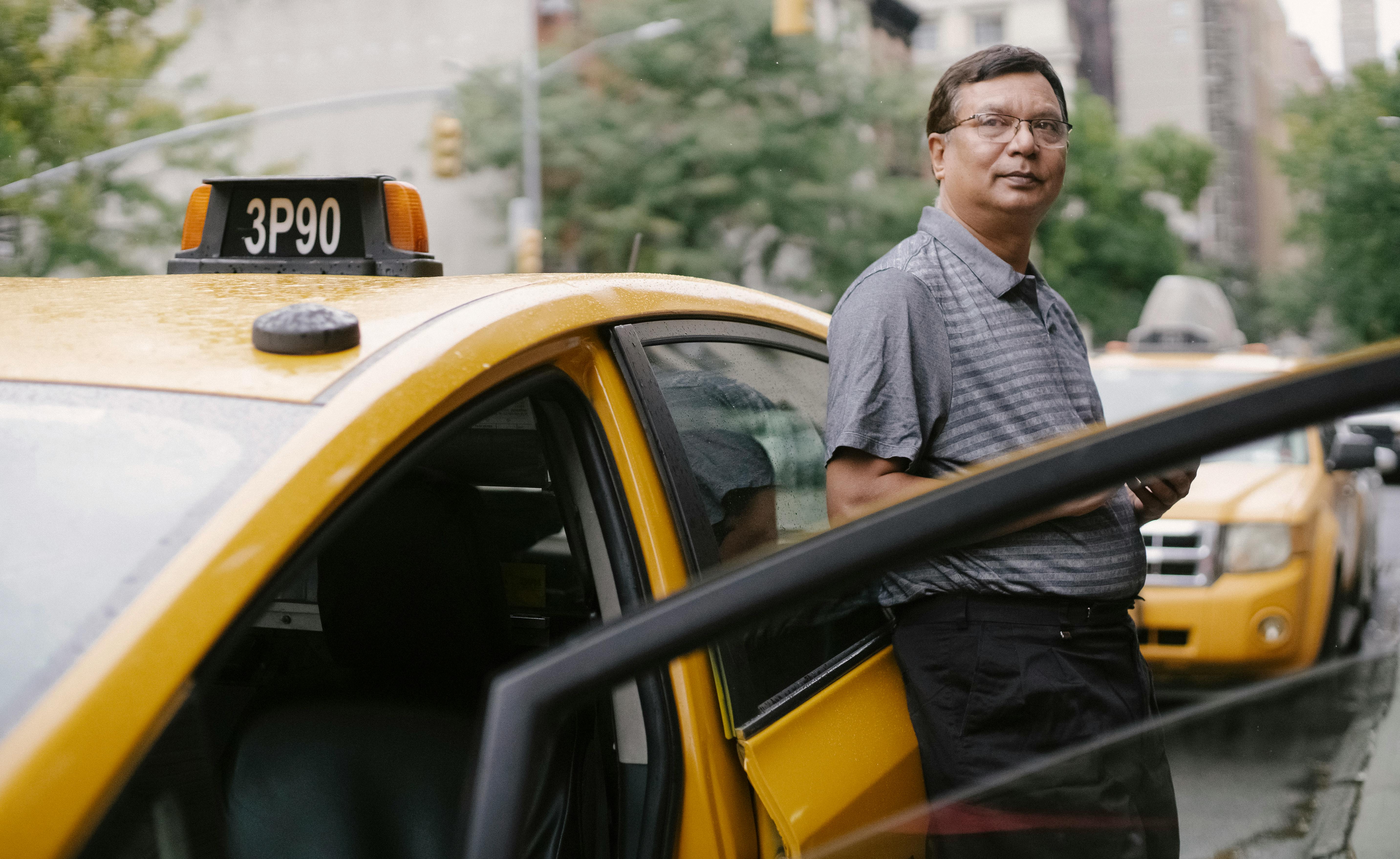 pensive man standing near taxi