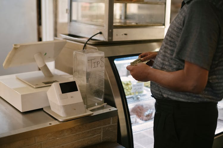 Crop Man Standing Near Cash Machine