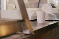 Paper cup of coffee on counter
