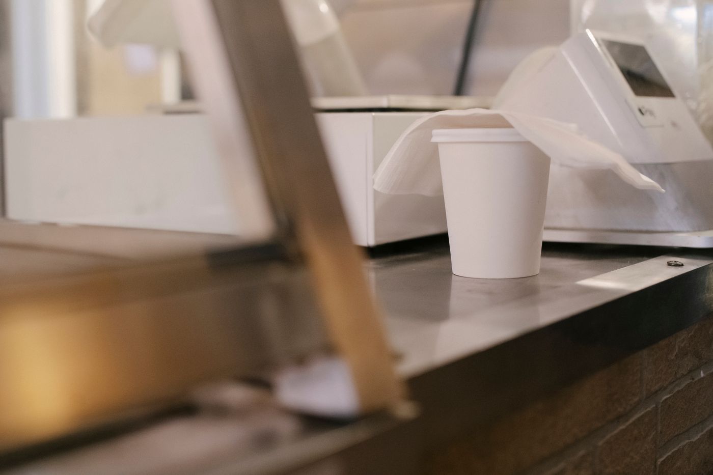 Paper takeaway coffee cup at a cafe counter