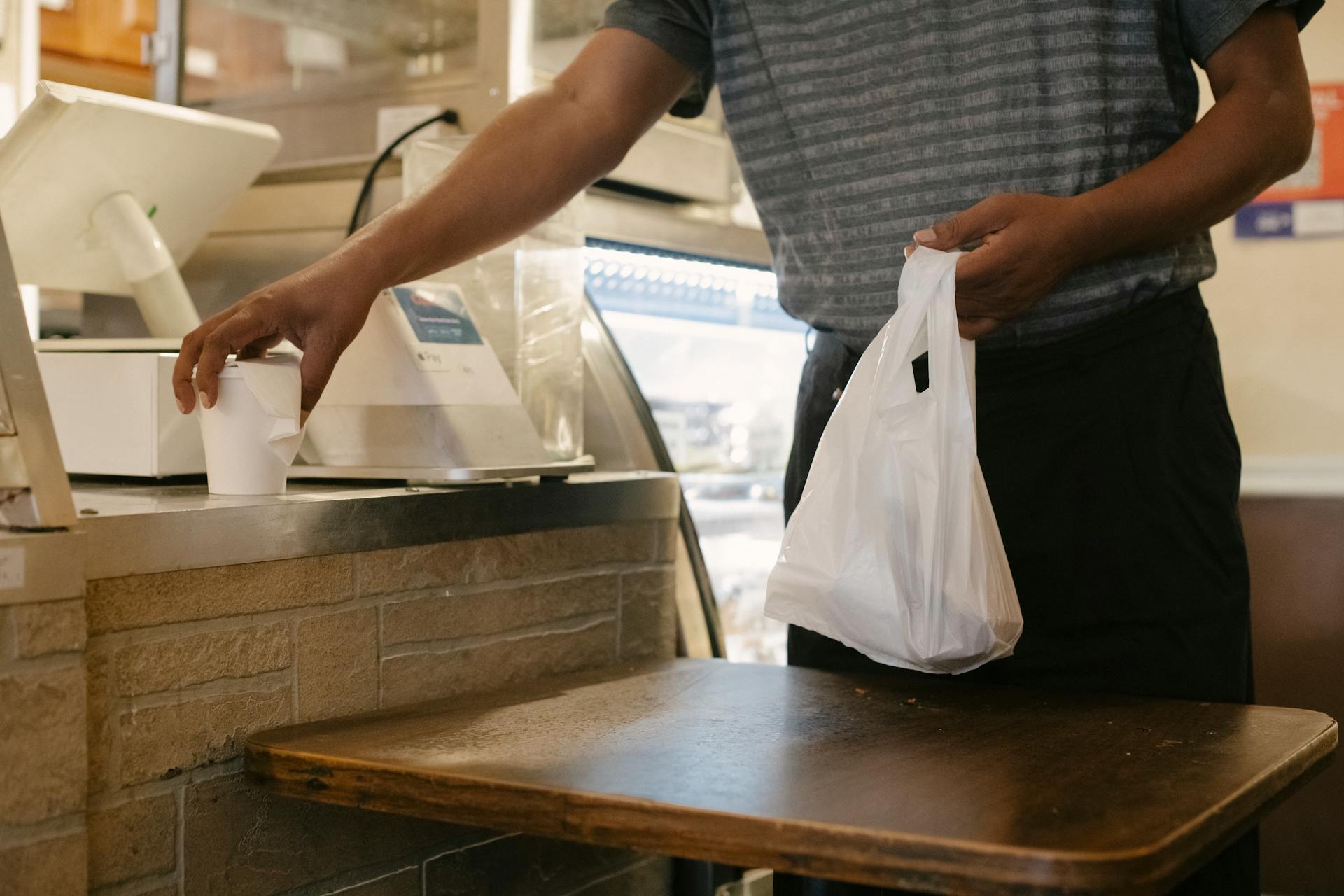 Crop man with purchases in store