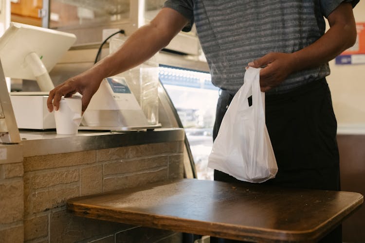 Crop Man With Purchases In Store