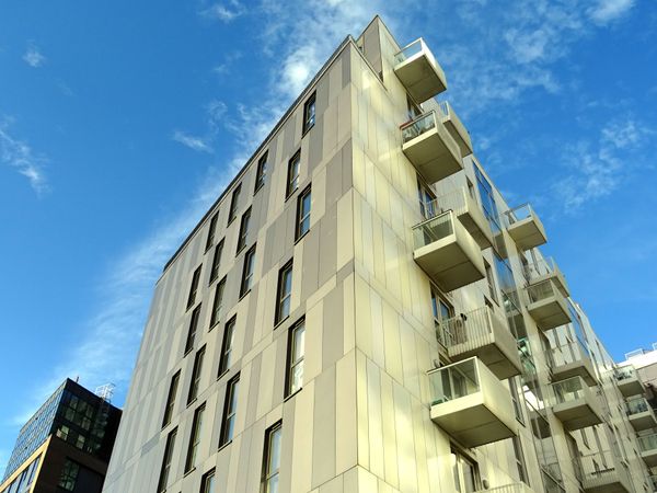 Low-angle view of a high-rise apartment building with balconies, the kind of building that needs an elevator move plan