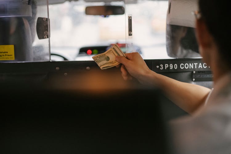 Customer Paying For Taxi Service In Dollars