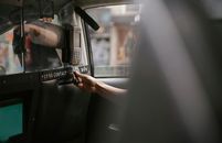 Passenger using credit card for paying taxi ride