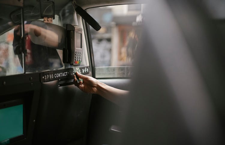 Passenger Using Credit Card For Paying Taxi Ride