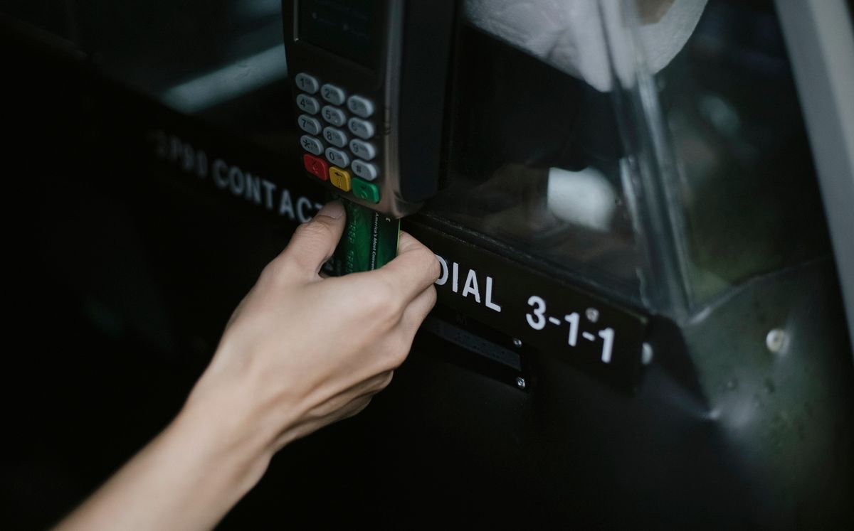 A traveller paying by card using a terminal inside a taxi