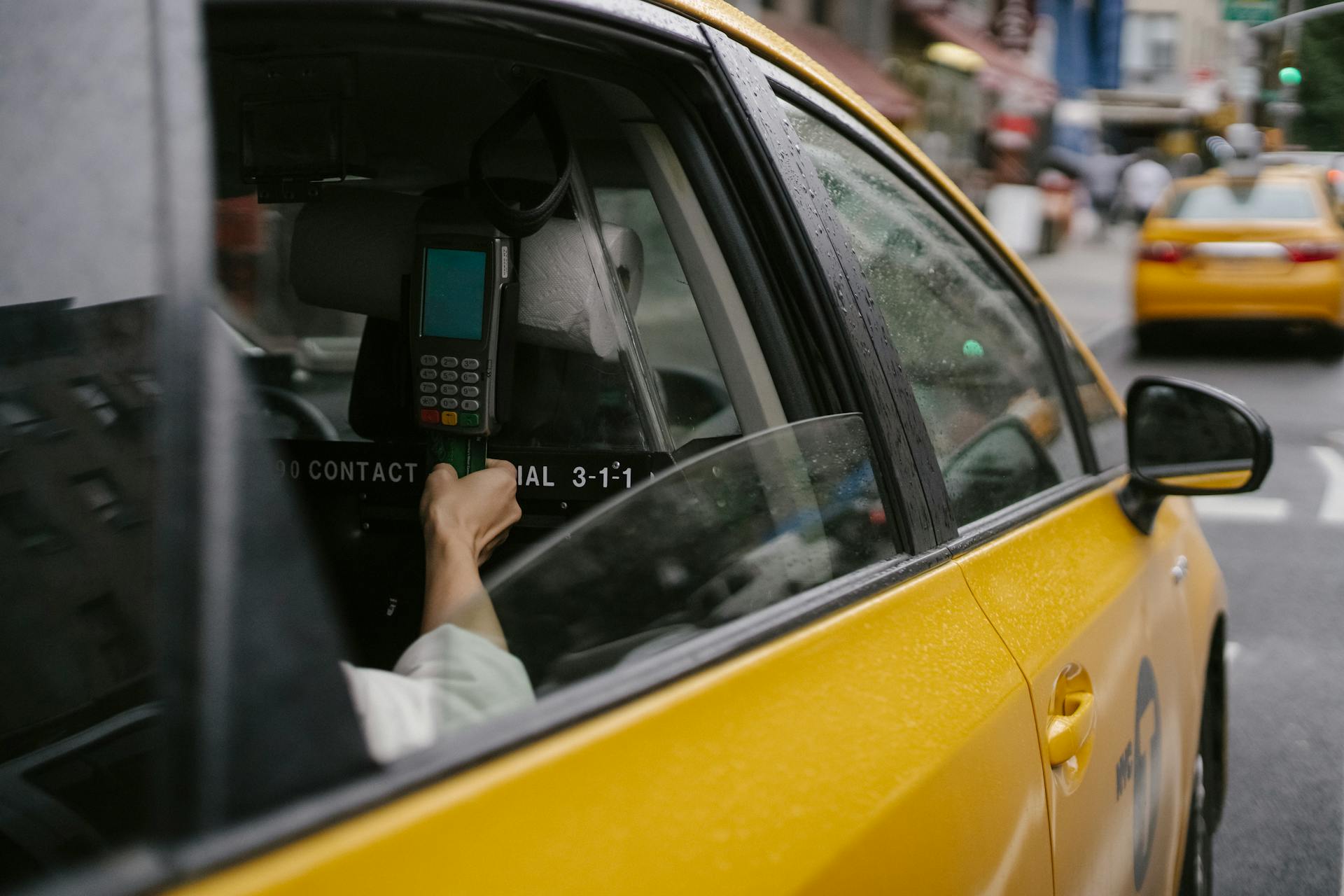 Anonymous person paying for taxi ride by credit card