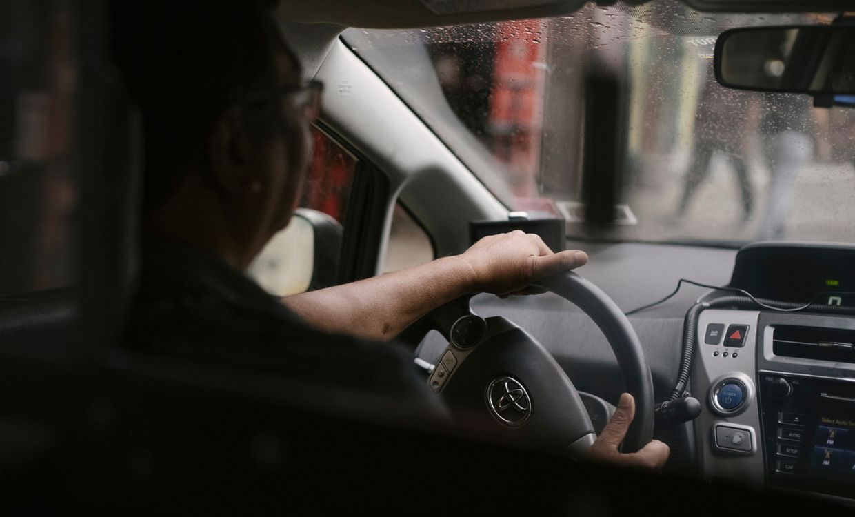 Driver siting in car in rainy weather