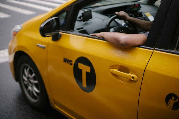 Taxi Driver In Car Riding On Road