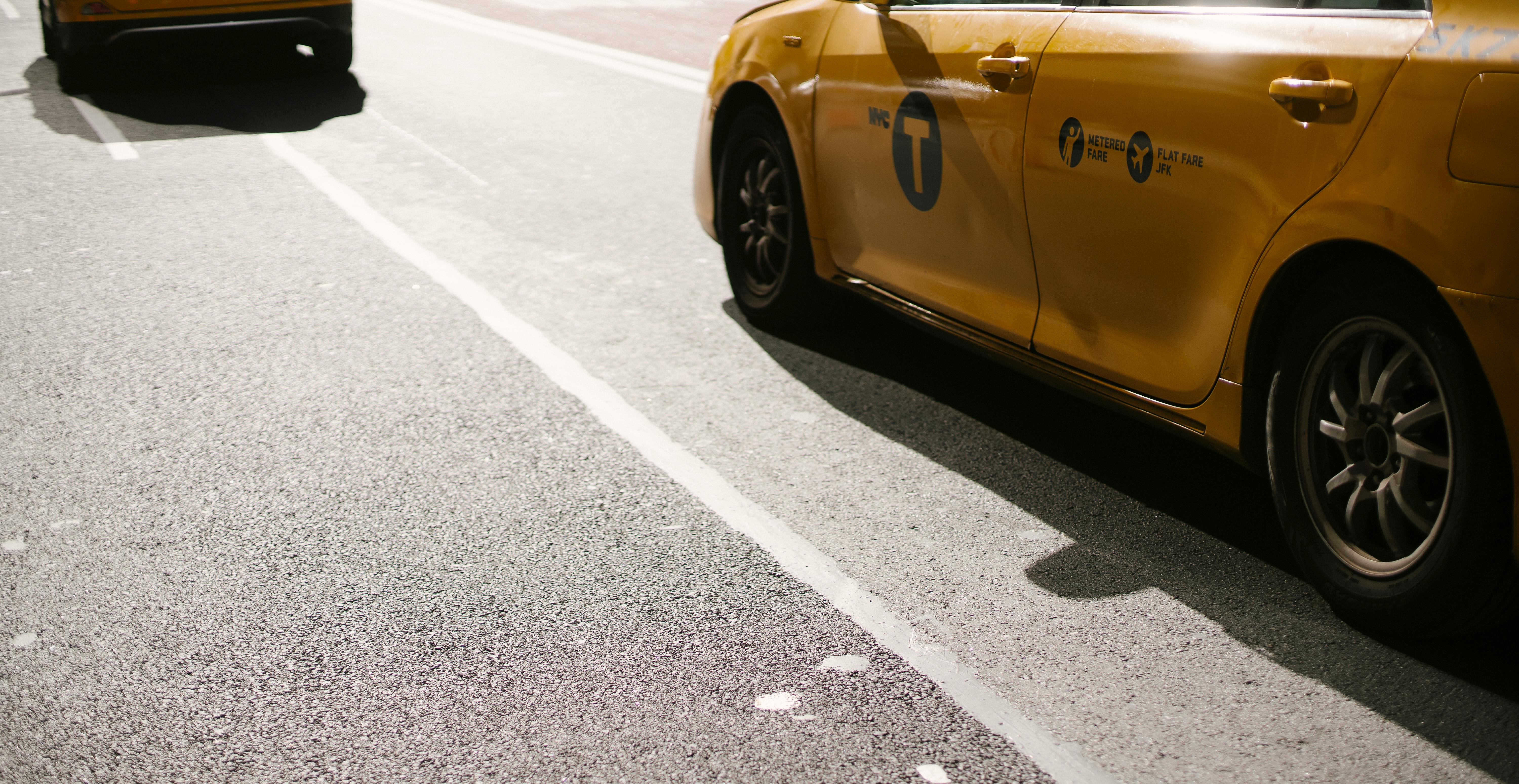 modern colorful yellow cars riding along road in suburb