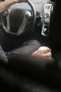 Unrecognizable driver with cup of coffee