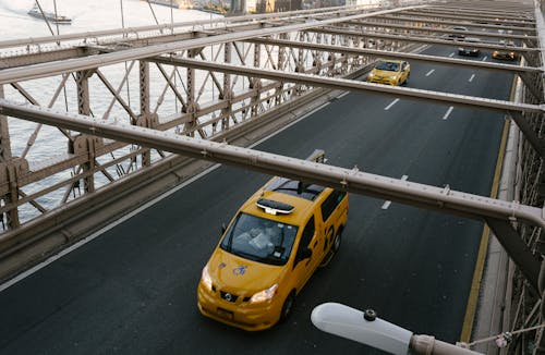 Free Taxi cabs driving on suspension bridge Stock Photo