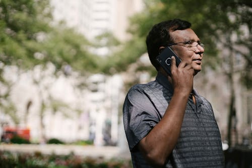 Free Man talking on phone on street Stock Photo