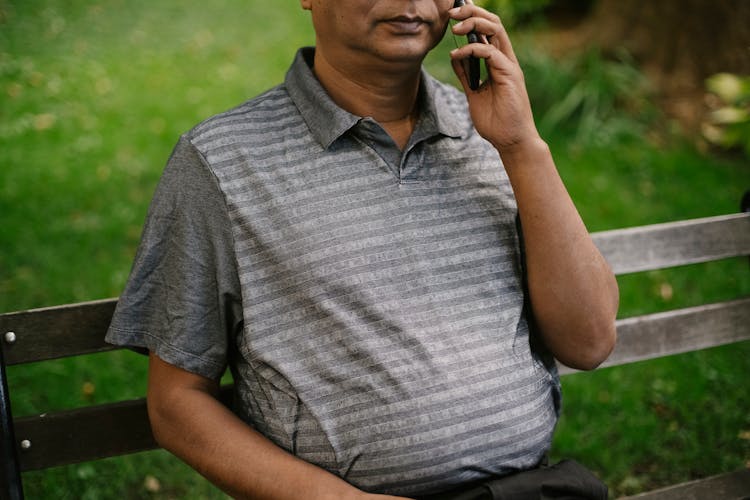 Male Talking On Phone In Park