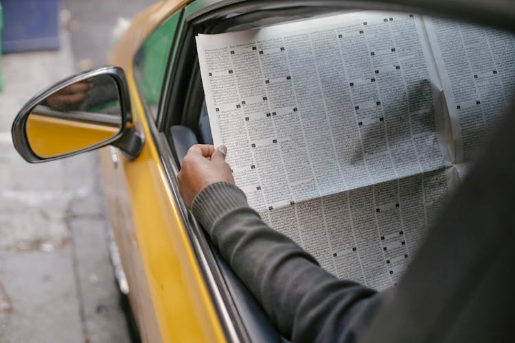 Person Reading Newspaper Sitting In Car