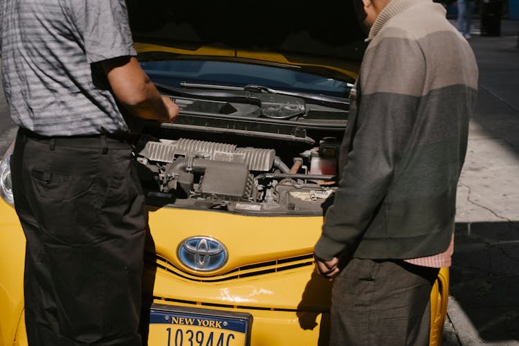 Men Fixing Problem In Motor Of Car