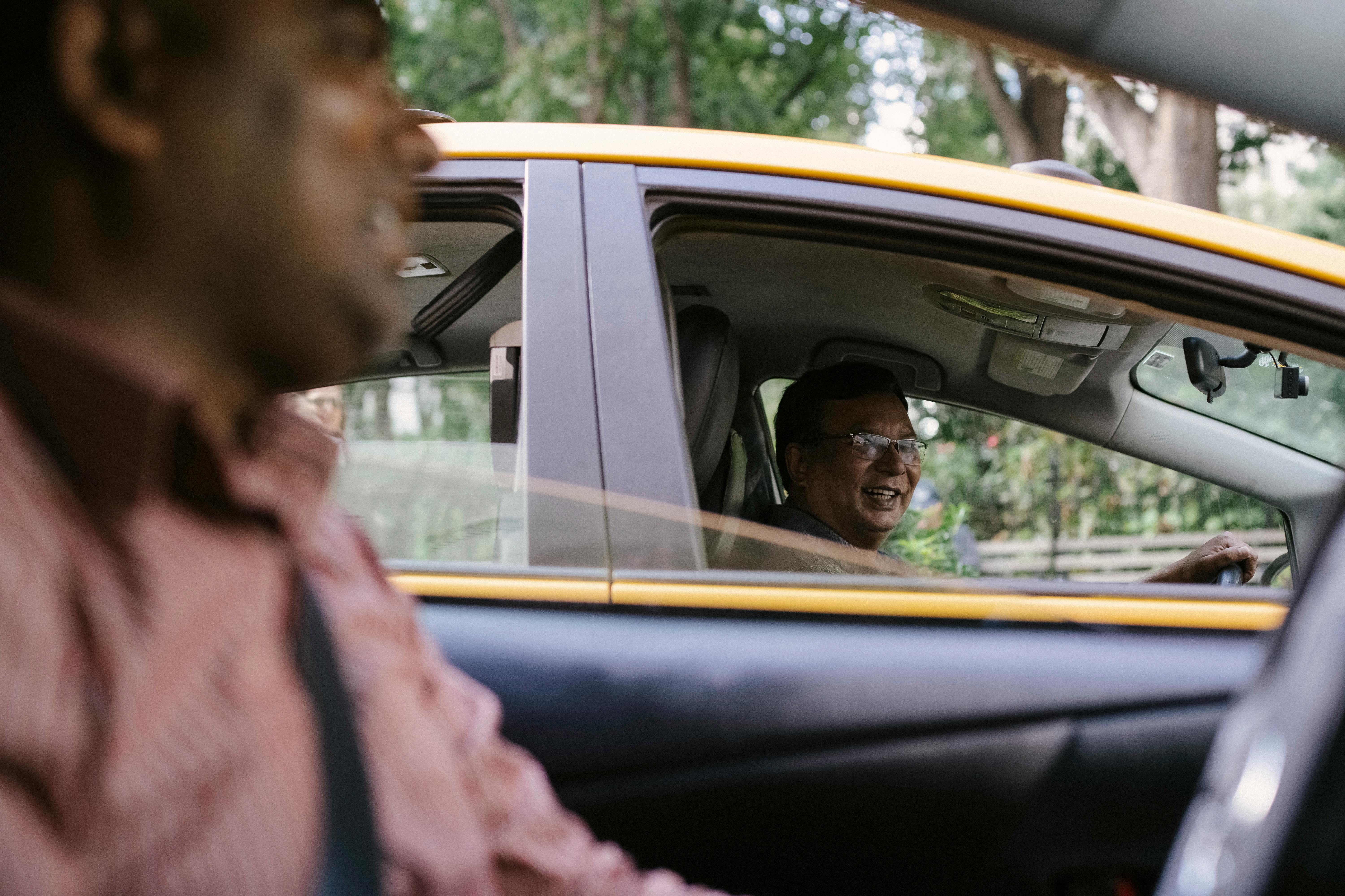 crop cheerful diverse taxi drivers talking in cars