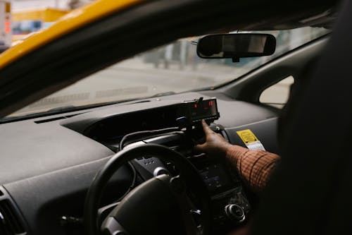 Free Crop ethnic man with navigator in taxi Stock Photo