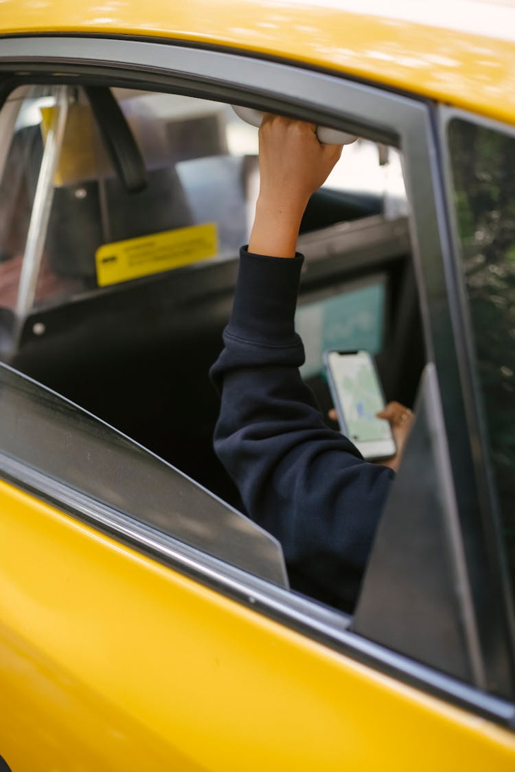 Crop Passenger Sitting In Taxi