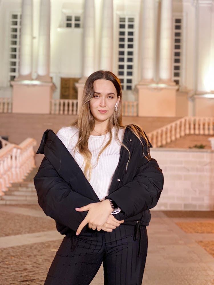 Woman In Black Winter Jacket Standing With Hands Crossed