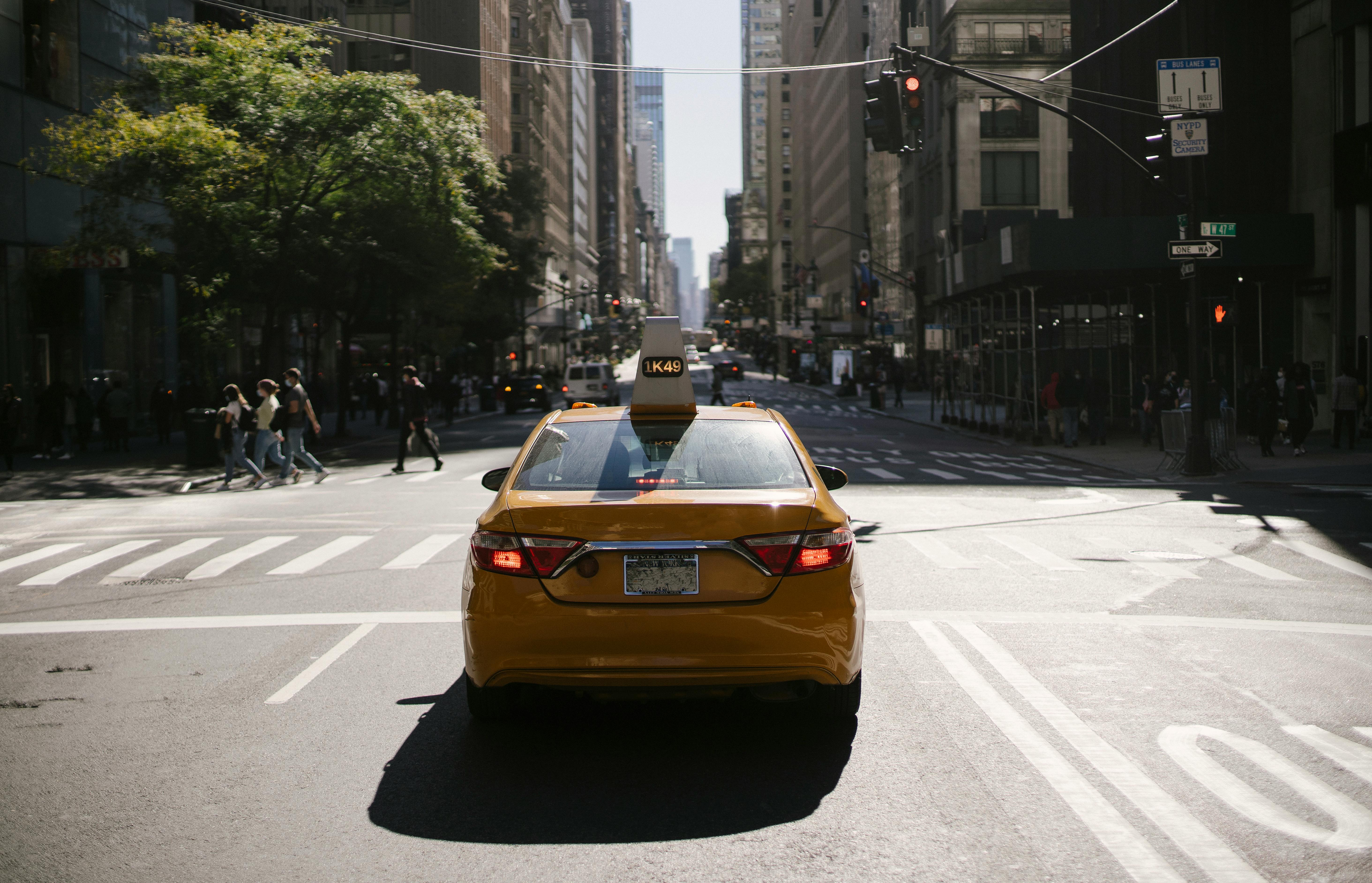 modern yellow cab on city road