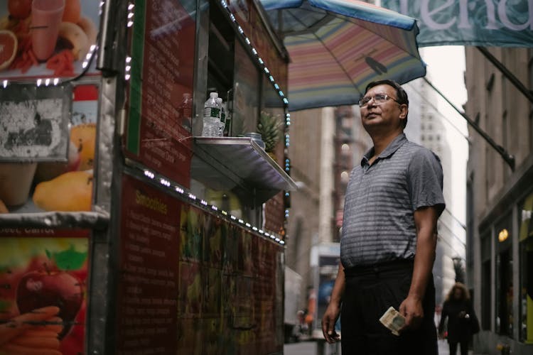 Ethnic Man Standing Near Food Truck