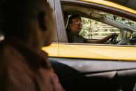 Ethnic men communicating in cars on road