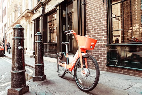 Free Orange Bicycle Parked on Sidewalk Stock Photo