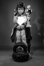 Grayscale Photo of a Child Holding a Trophy