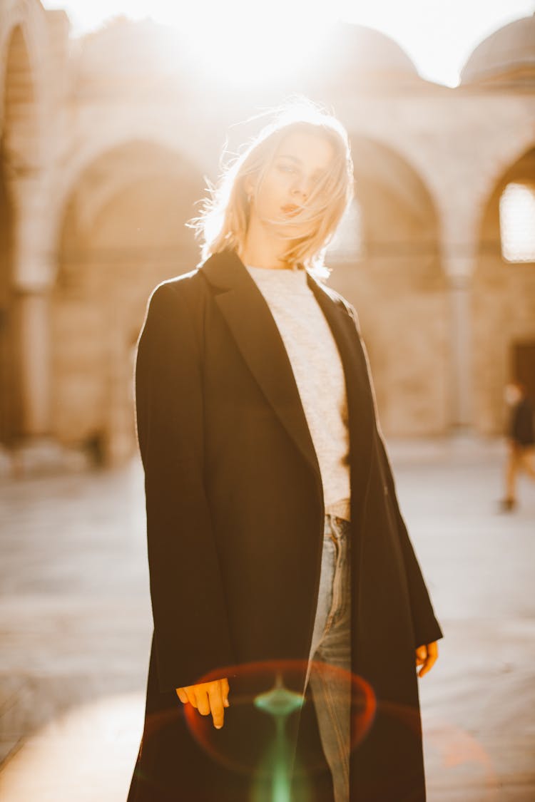 Woman In Black Coat Standing Against The Light