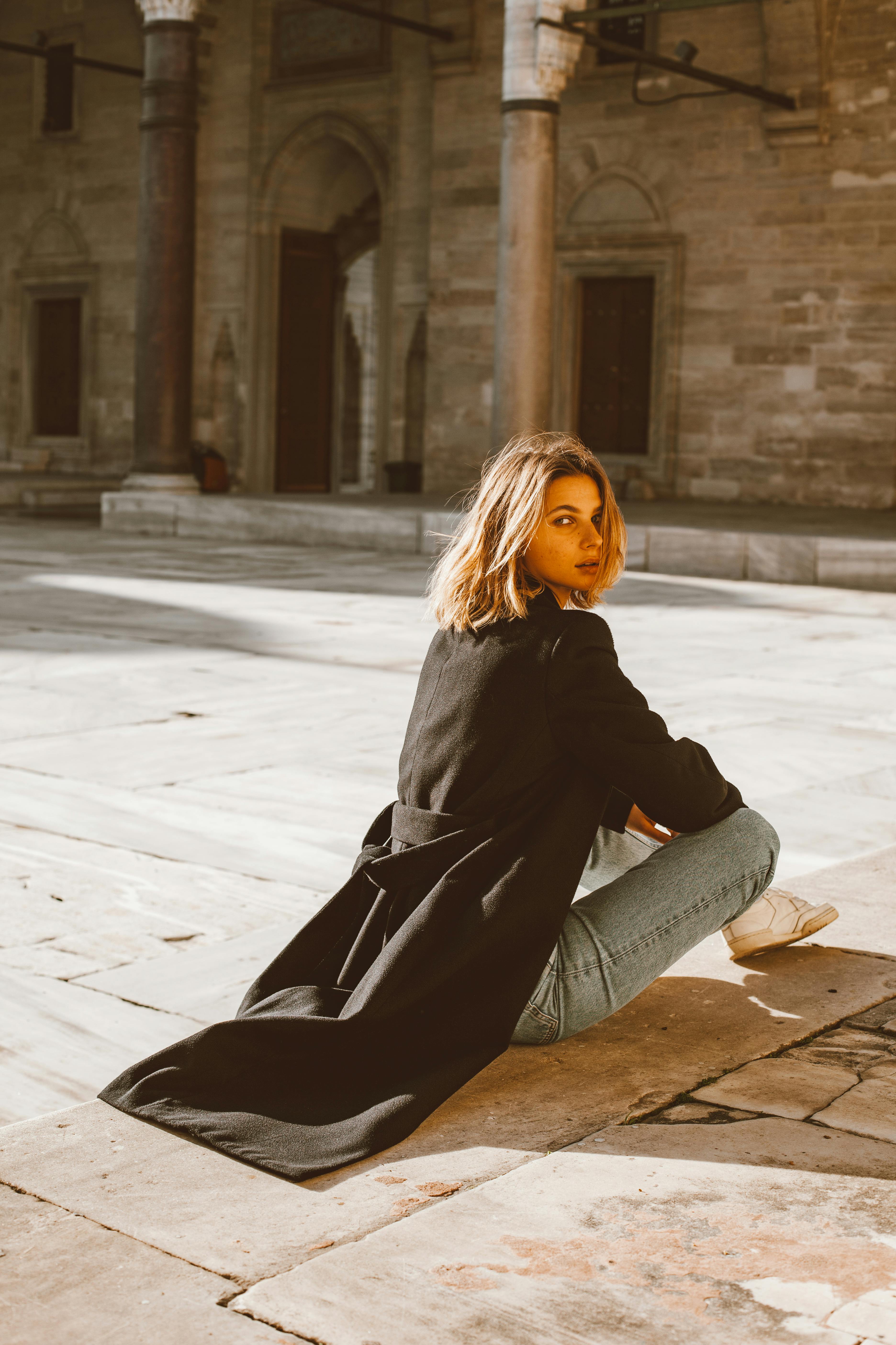 back view of a woman wearing black coat looking over shoulder