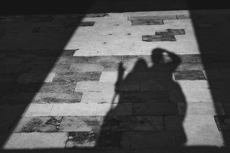 Shadow Of People On Concrete Floor