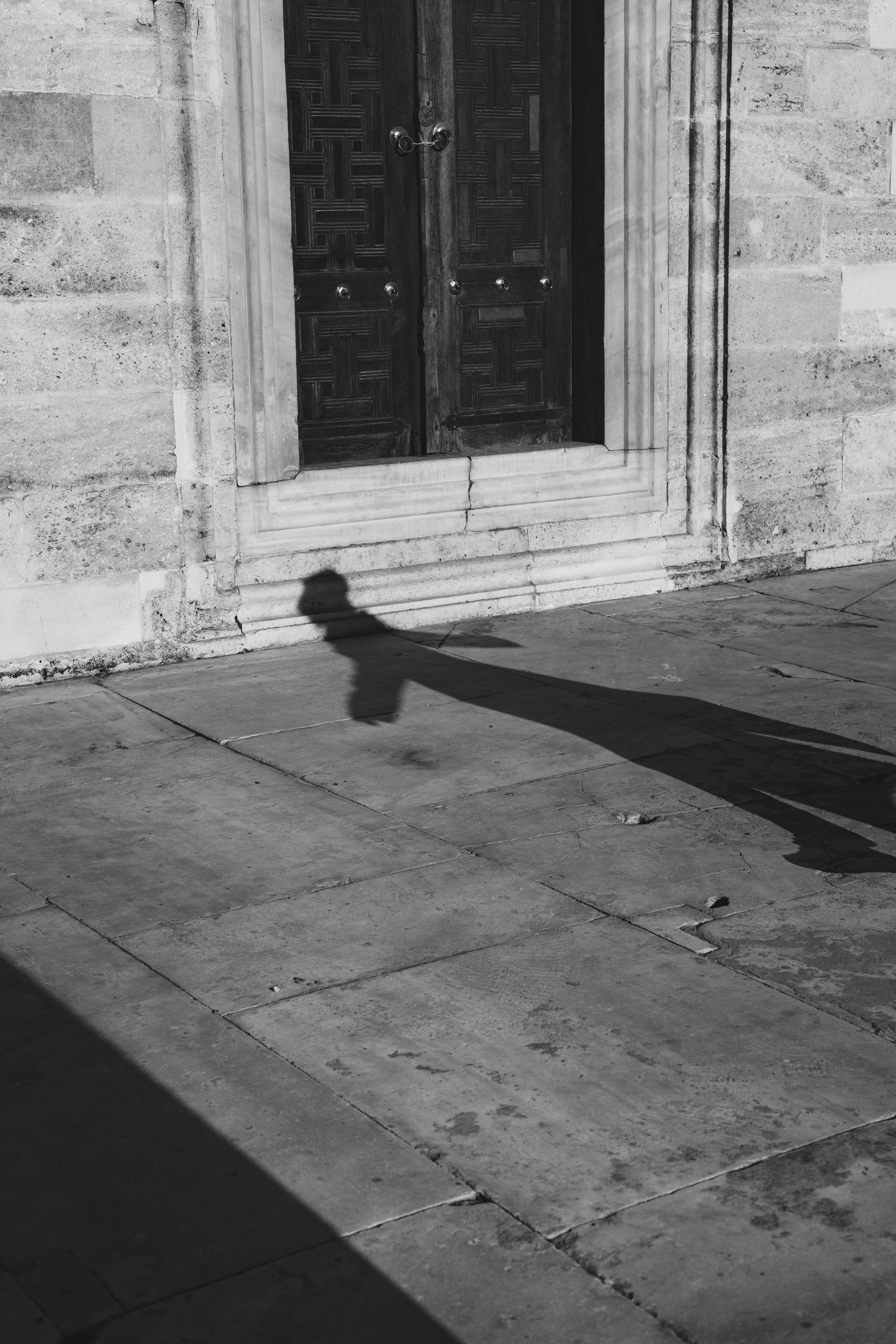 grayscale photo of shadow on concrete floor