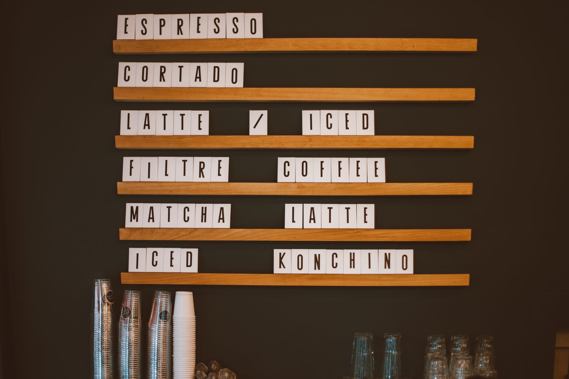 Stylish coffee shop menu board featuring various drinks like espresso and cortado.