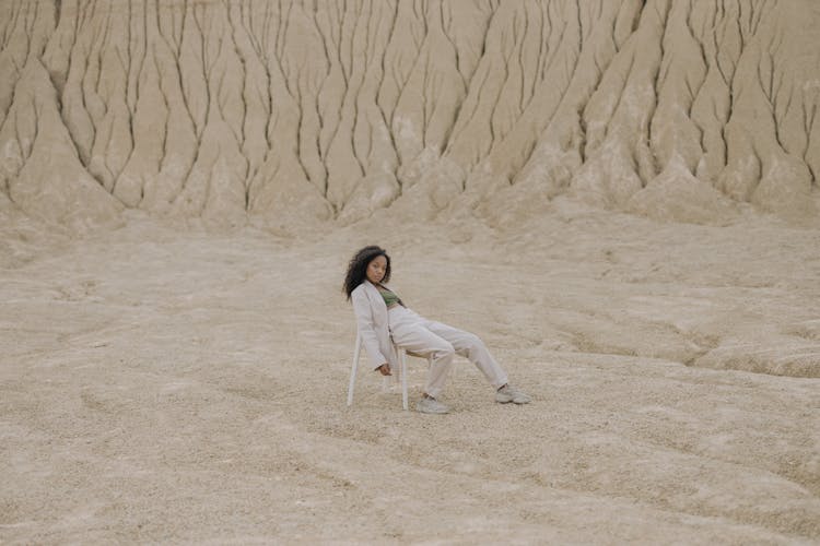 Woman In White Long Sleeve Pajama Sitting On Chair