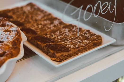 Mouthwatering close-up of gooey chocolate dessert with sesame seeds on display.