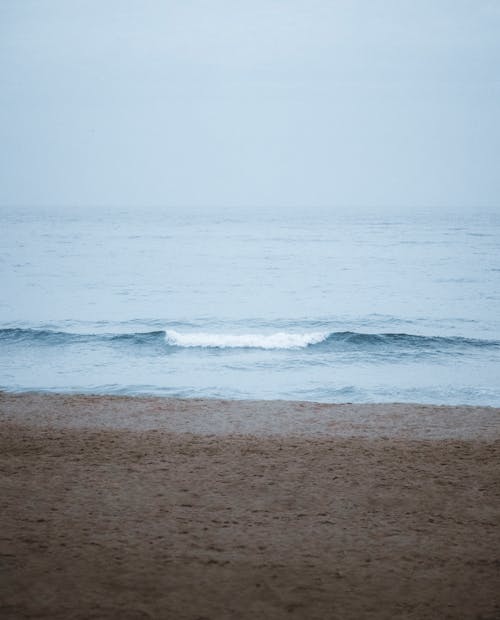 Free crashing Waves on Beach Shore Stock Photo