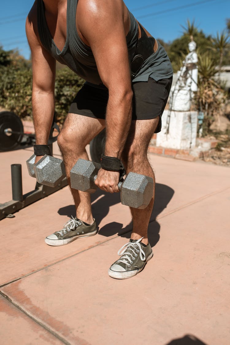 Man In Tank Top Lifting Dumbbells