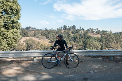 ブラックマウンテンバイクに乗るブラックジャケットの男