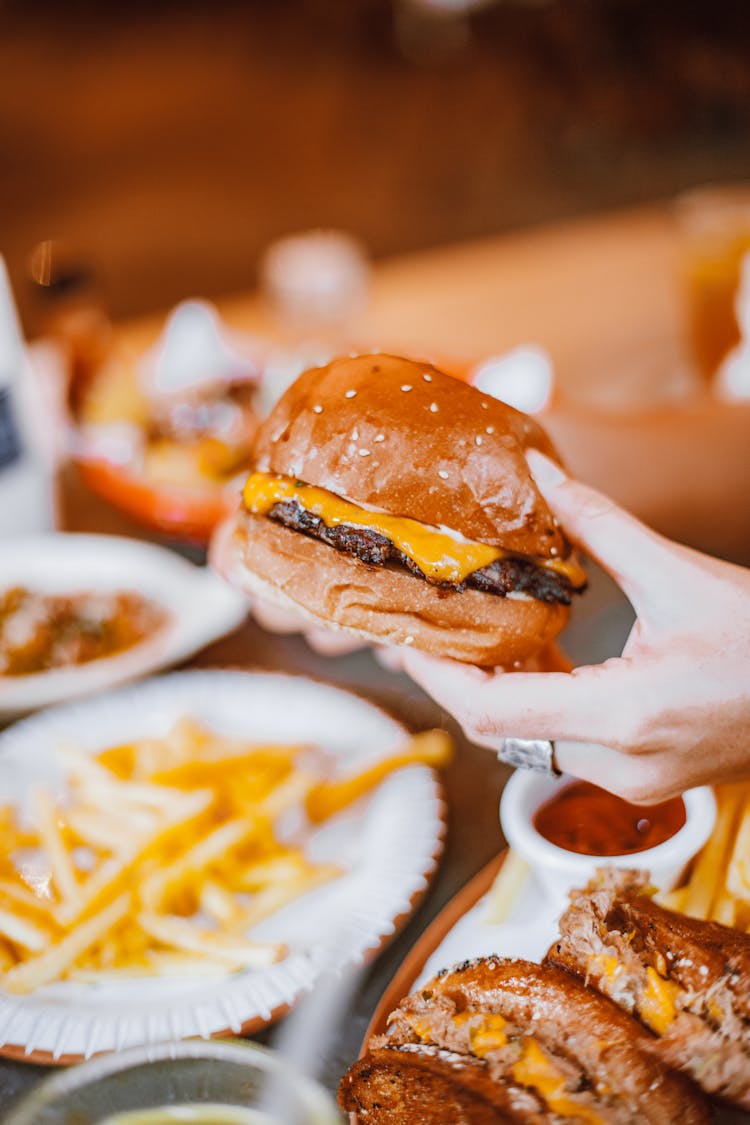 Person Holding Tasty Burger