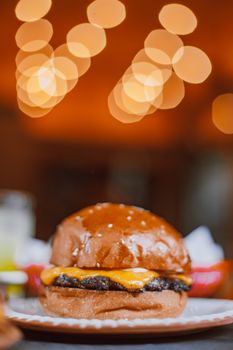 Tasty cheeseburger with a vibrant bokeh background, perfect for food photography.
