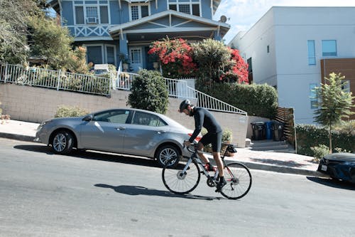 A Man Riding a Bicycle in an Uphill Road